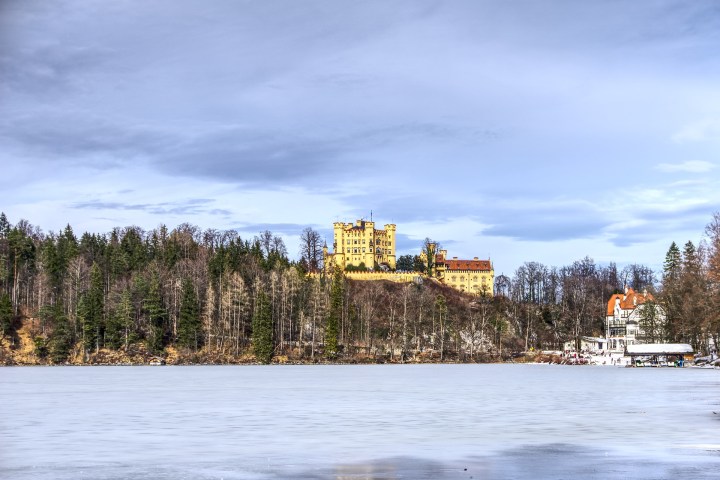 View of Neuschwanstein Castle in winter from a frozen lake